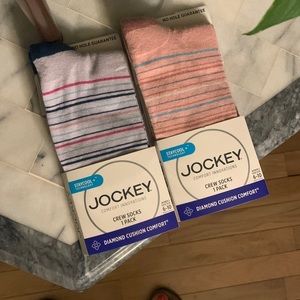 Two pairs of women's crew socks by Jockey.  Striped pink and one striped blue